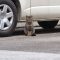 prima sitting in front of car